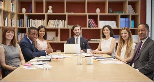 group of professionals setting around a conference table